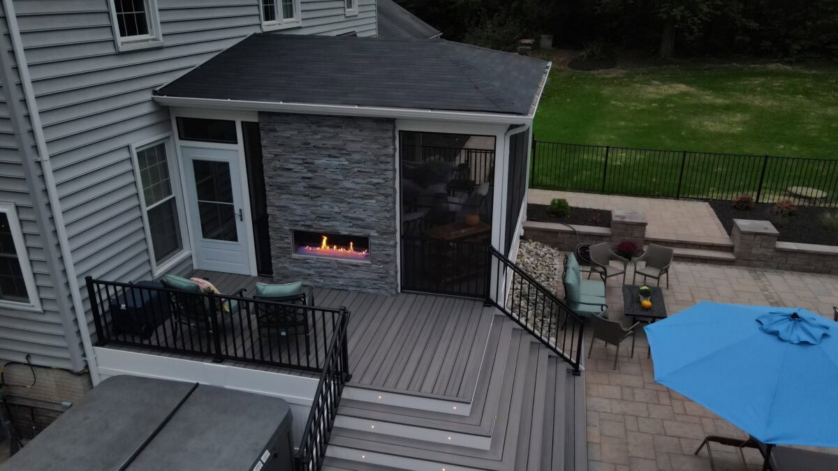 Covered porch with built-in fire pit and patio heater for year-round use in Northern Virginia