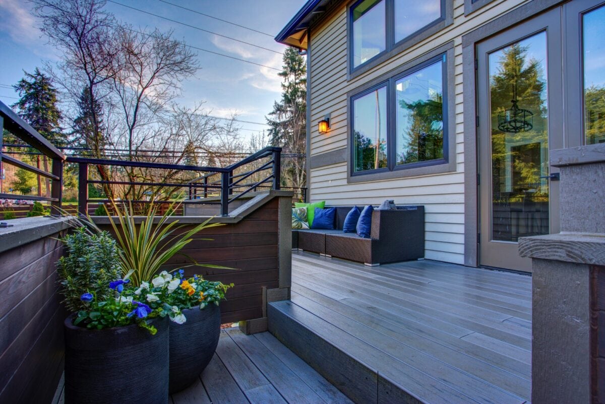 Raised composite deck with modern furniture and planters in a Vienna, VA backyard