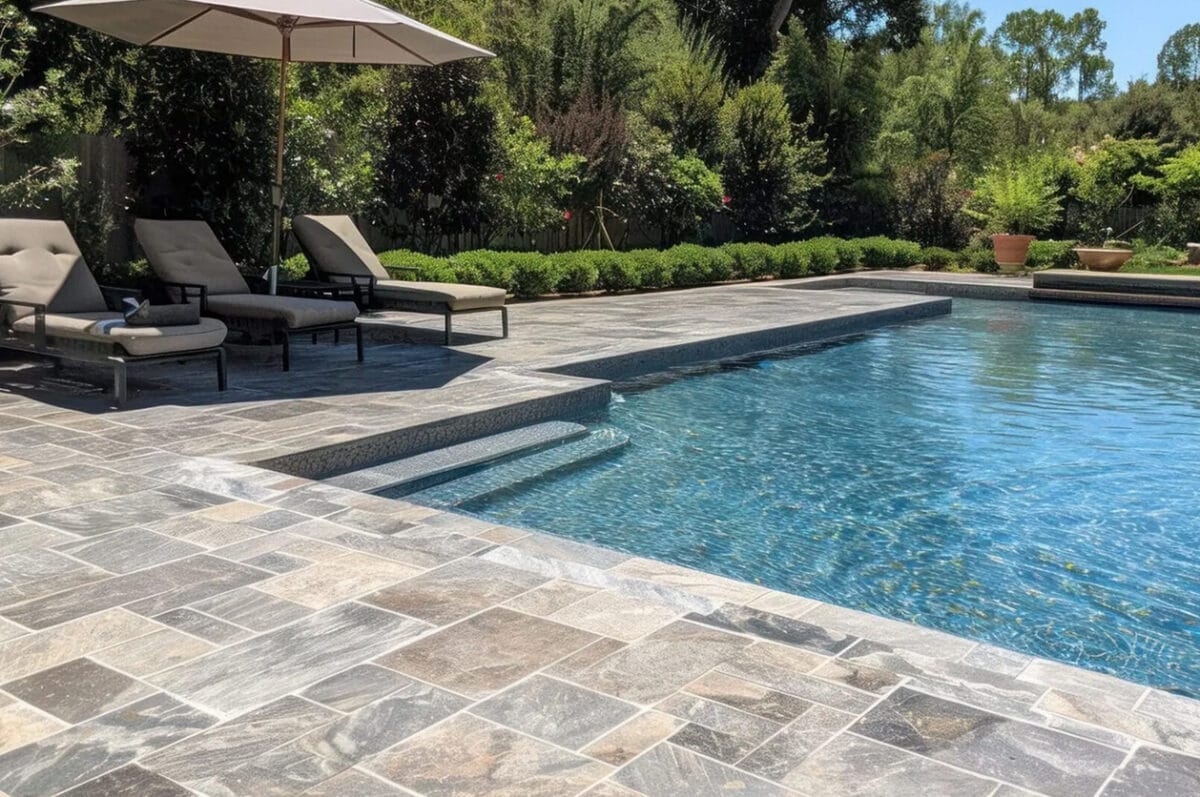 Luxury pool with stone patio and lounge chairs