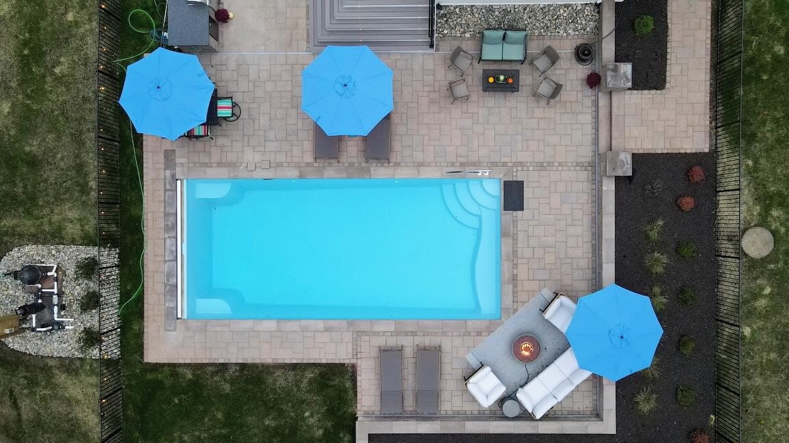 Aerial view of backyard pool and patio setup