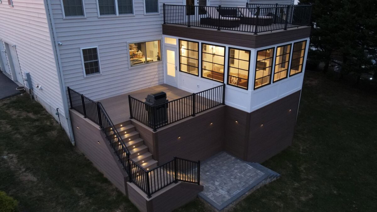 Elevated deck and sunroom addition with lighted stairs