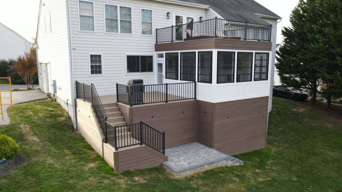 Elevated deck and sunroom with illuminated outdoor stairs